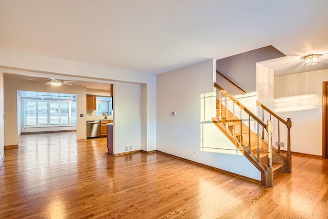 living room with hardwood / wood-style flooring, sink, and ceiling fan