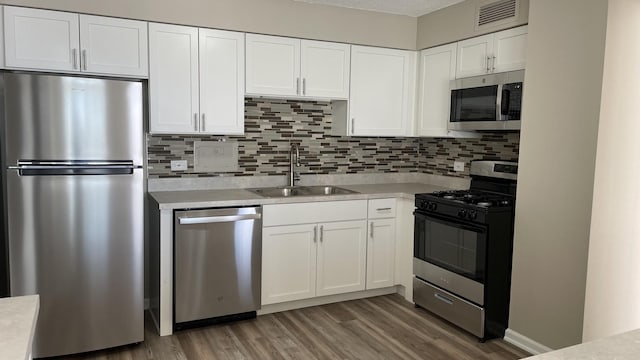 kitchen featuring stainless steel appliances, light countertops, visible vents, and white cabinetry