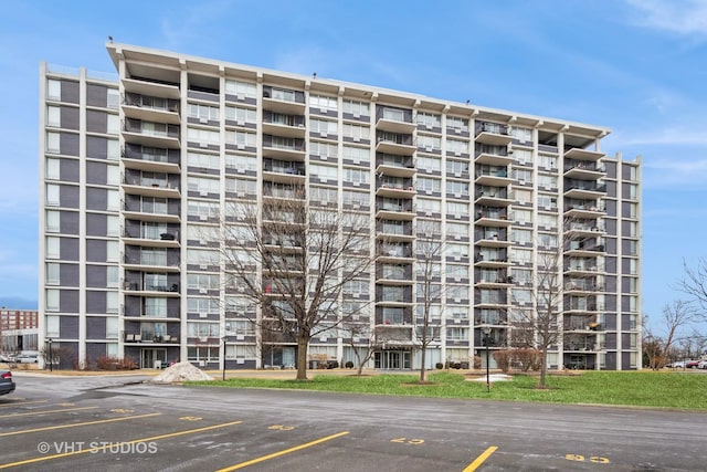 view of building exterior with uncovered parking