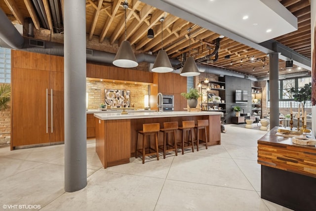 kitchen with a kitchen island with sink and a breakfast bar area