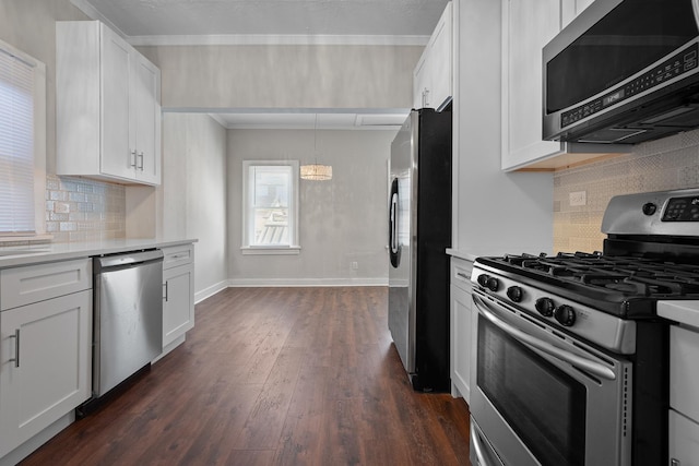 kitchen with dark wood-type flooring, white cabinetry, tasteful backsplash, decorative light fixtures, and stainless steel appliances