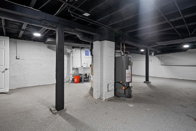 basement with gas water heater and sink