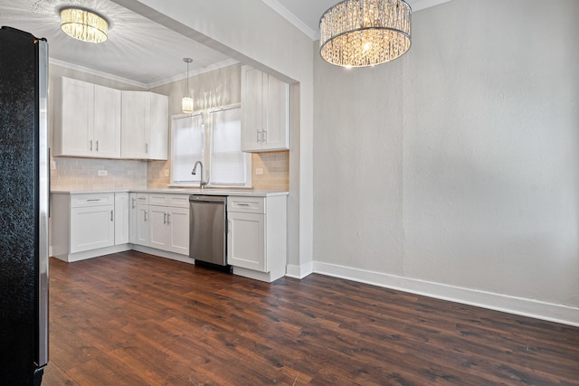 kitchen featuring pendant lighting, a notable chandelier, stainless steel appliances, and white cabinets