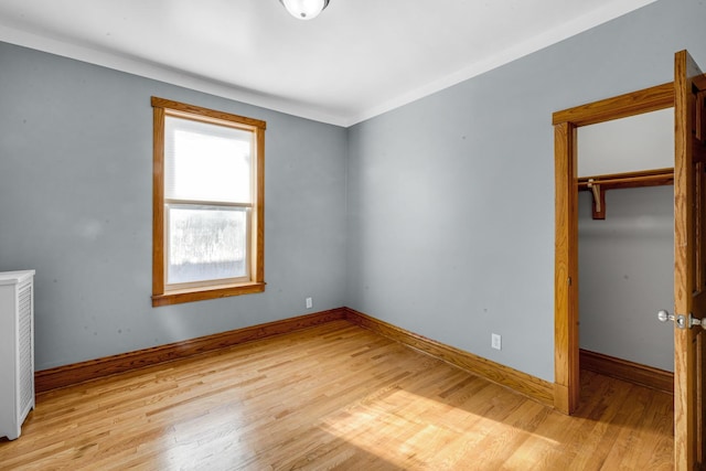 unfurnished bedroom with a closet and light wood-type flooring