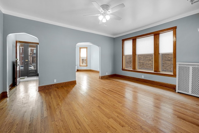 unfurnished room with radiator, crown molding, light hardwood / wood-style flooring, and ceiling fan