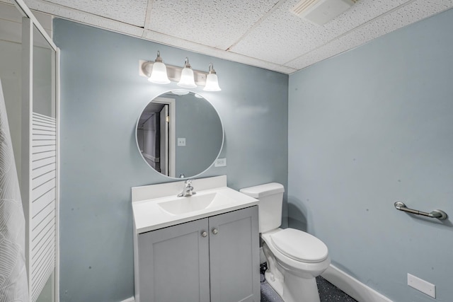 bathroom with vanity, a paneled ceiling, and toilet