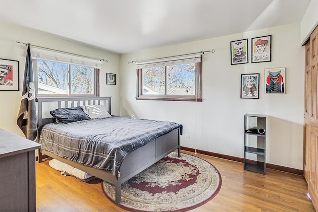 bedroom featuring baseboards and wood finished floors