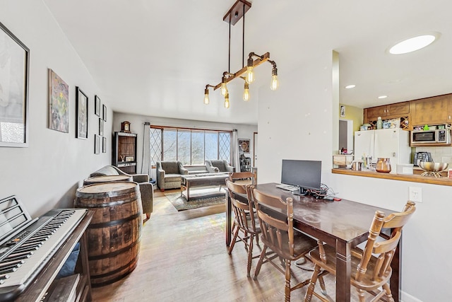 dining room with recessed lighting and light wood-style floors