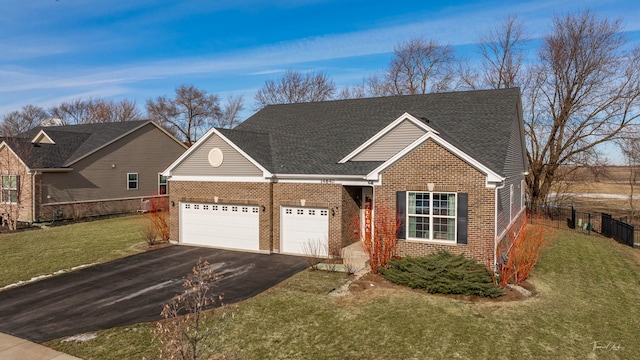 view of front of property with aphalt driveway, brick siding, a shingled roof, an attached garage, and a front lawn