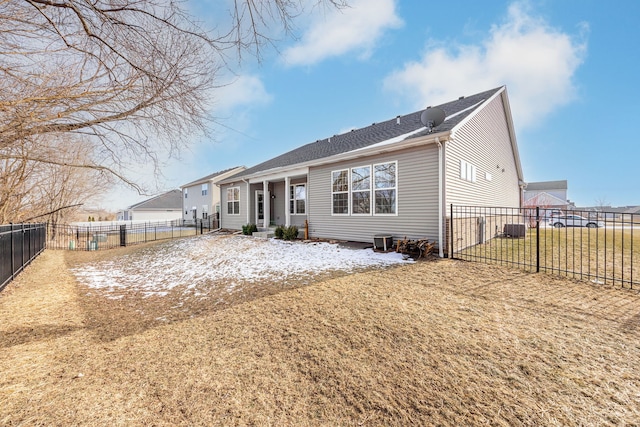 rear view of house featuring a fenced backyard and a lawn