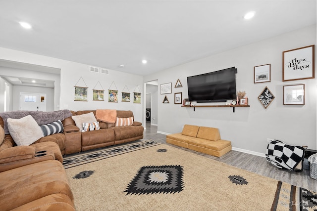 living area with baseboards, wood finished floors, visible vents, and recessed lighting