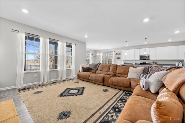 living area with recessed lighting, baseboards, and wood finished floors