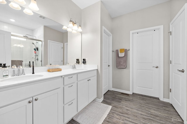 full bathroom featuring a stall shower, visible vents, a sink, and double vanity