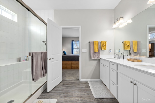 full bath featuring a healthy amount of sunlight, a sink, a shower stall, and ensuite bath