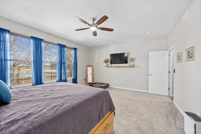 bedroom with carpet floors, visible vents, baseboards, and a ceiling fan