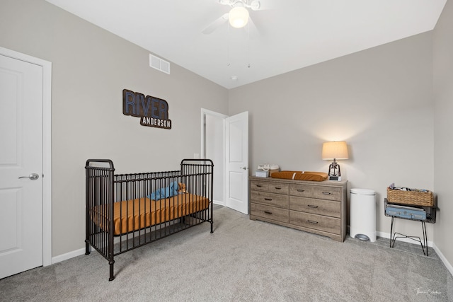 carpeted bedroom with baseboards, visible vents, and a ceiling fan