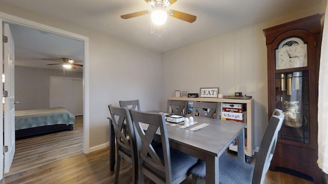 dining area with hardwood / wood-style floors and ceiling fan