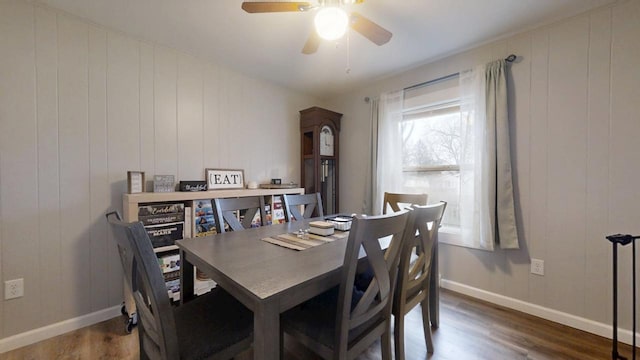 dining room with ceiling fan and dark hardwood / wood-style flooring