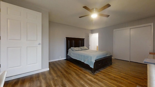 bedroom with dark hardwood / wood-style floors, ceiling fan, and a closet