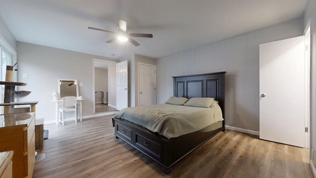 bedroom with dark hardwood / wood-style flooring and ceiling fan