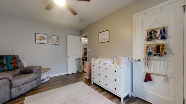 interior space featuring dark wood-type flooring and ceiling fan