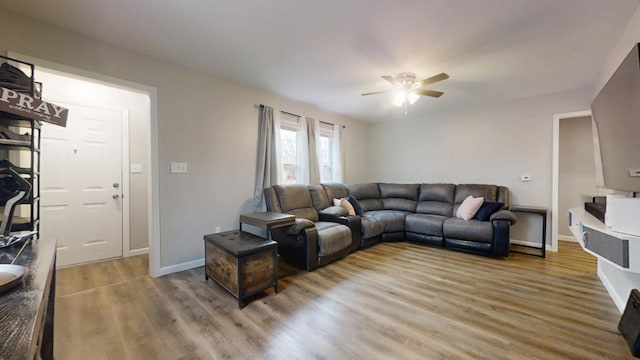 living room with hardwood / wood-style floors and ceiling fan