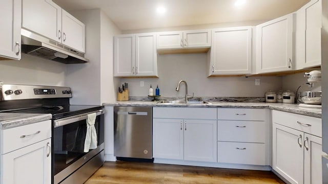 kitchen with sink, stainless steel appliances, and white cabinets