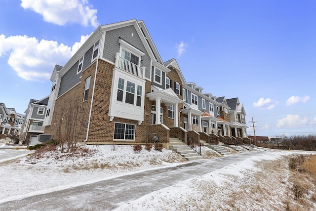 snow covered property featuring central air condition unit