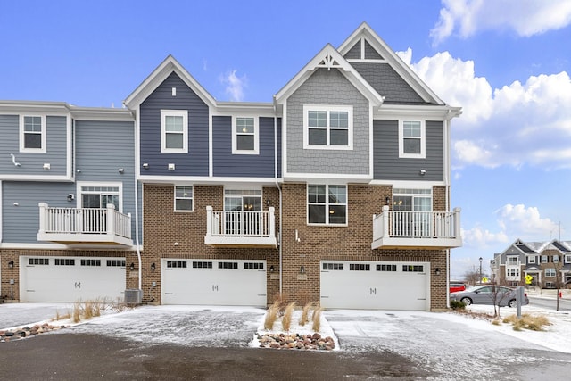 townhome / multi-family property featuring a garage and central air condition unit