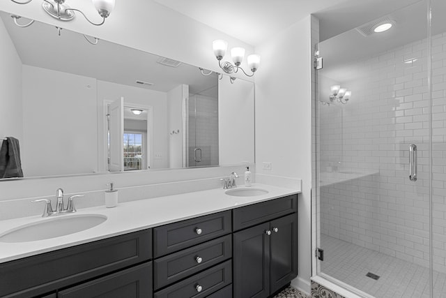 bathroom featuring vanity and a shower with shower door