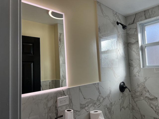 bathroom with tile walls and tiled shower