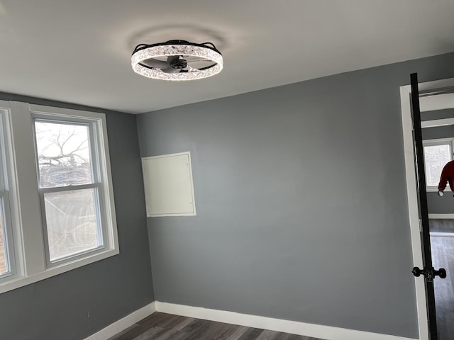 spare room with plenty of natural light and dark hardwood / wood-style floors