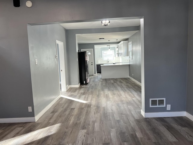 corridor with wood-type flooring