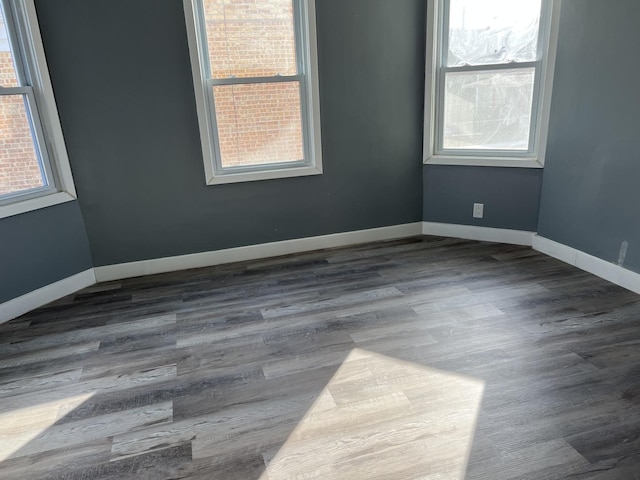 spare room with dark hardwood / wood-style flooring