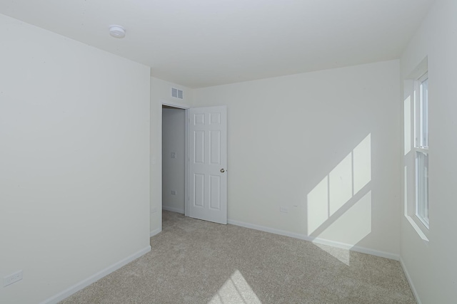 spare room with light carpet