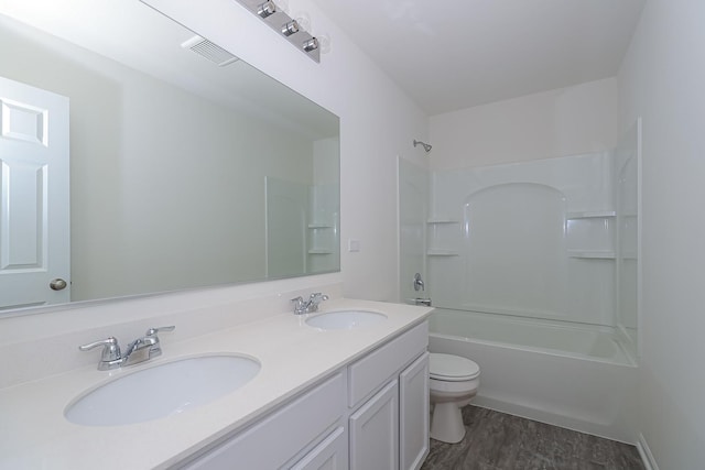 full bathroom with  shower combination, vanity, and toilet