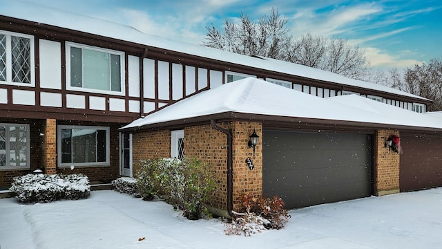 view of snow covered exterior featuring a garage