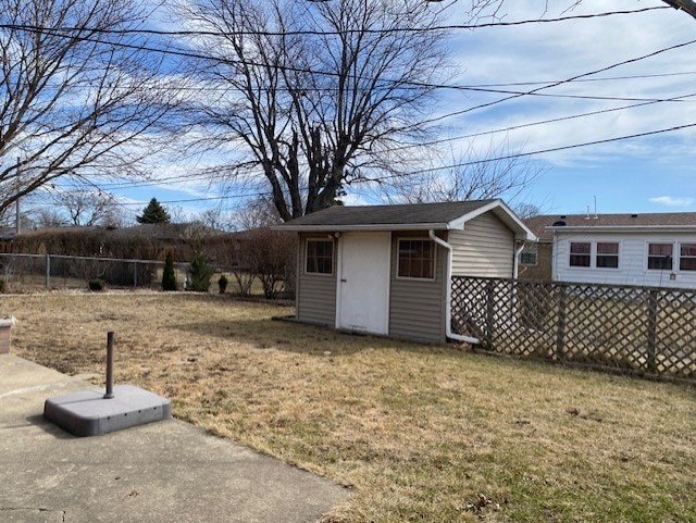 view of yard featuring an outbuilding and fence private yard