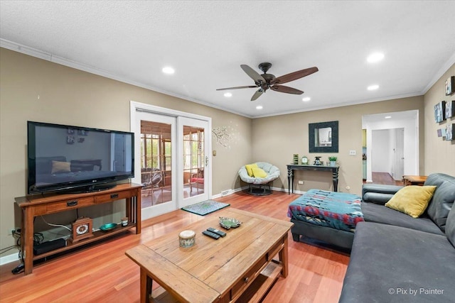 living room featuring french doors, ceiling fan, crown molding, and hardwood / wood-style floors