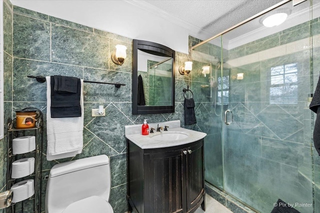 bathroom with crown molding, tile walls, vanity, an enclosed shower, and toilet