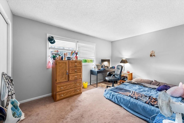 bedroom featuring carpet flooring and a textured ceiling