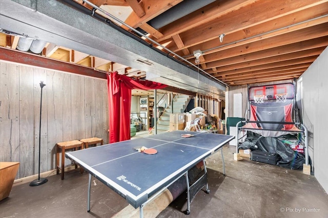 recreation room featuring wooden walls