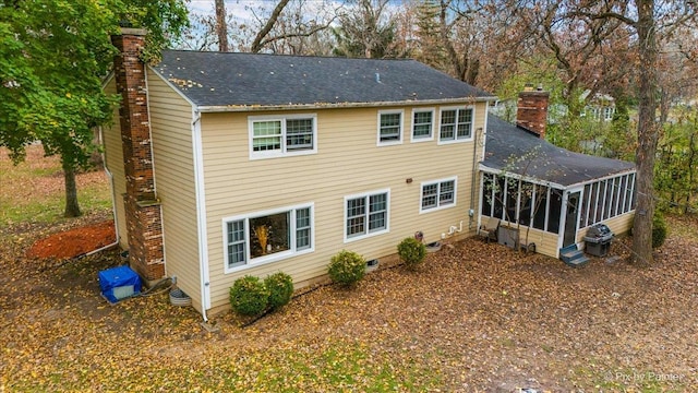 back of house featuring a sunroom