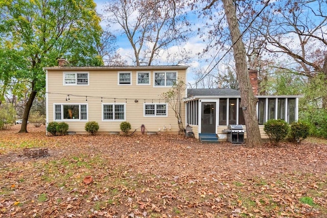 back of house featuring a sunroom