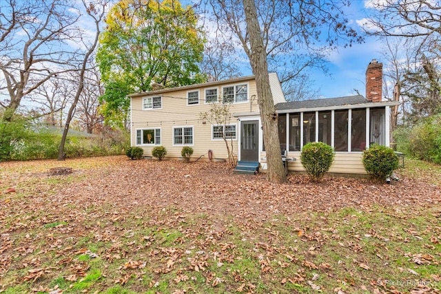 rear view of property with a sunroom