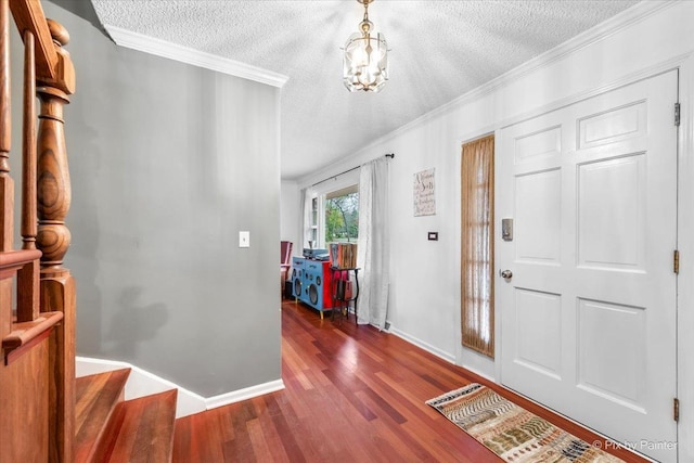 foyer with crown molding, dark hardwood / wood-style floors, and a textured ceiling