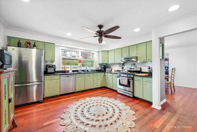 kitchen with sink, stainless steel appliances, and green cabinetry