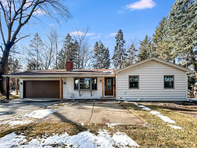 ranch-style house featuring driveway, a chimney, and an attached garage