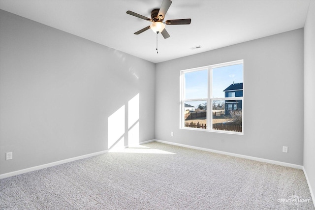 spare room with light colored carpet and ceiling fan