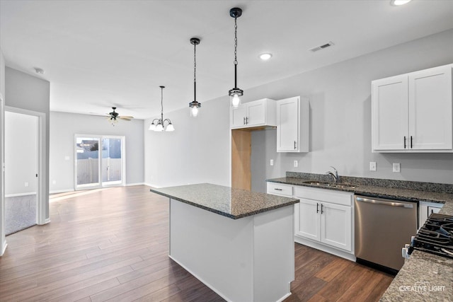 kitchen with white cabinetry, dark stone counters, dishwasher, and sink